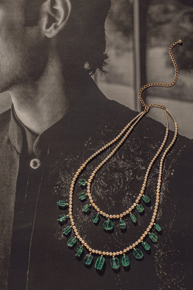 Two-string
Pearl necklace with emerald pebble drops